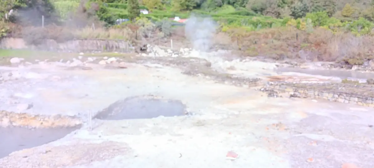 Steaming mineral ground and fumaroles on the shore of Furnas lake
