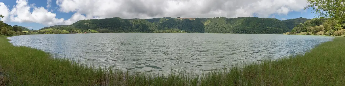 Wide view of Furnas lake with wooded hills on the far shore