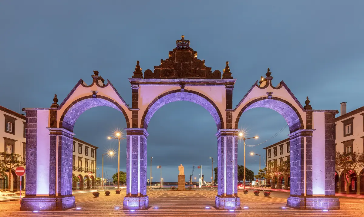 Illuminated city gates of Ponta Delgada in the blue light of dusk