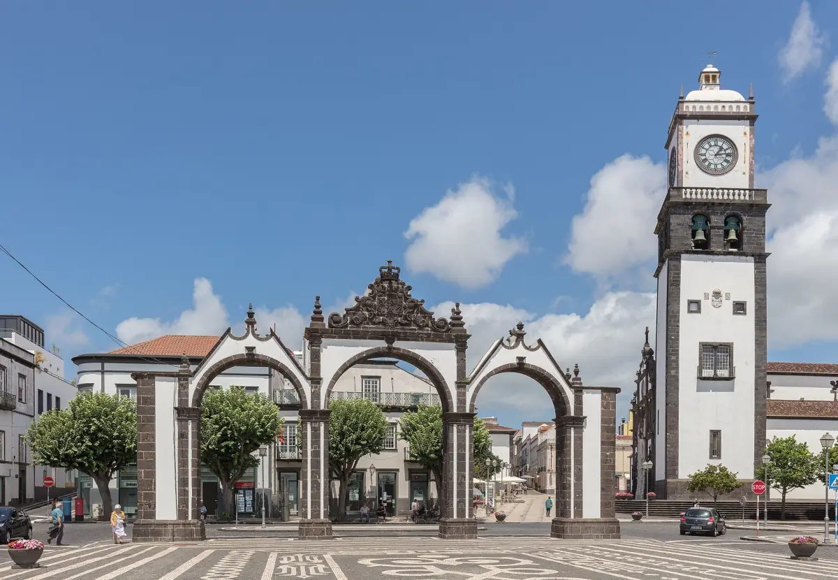 City gates and church tower on a sunny square in Ponta Delgada