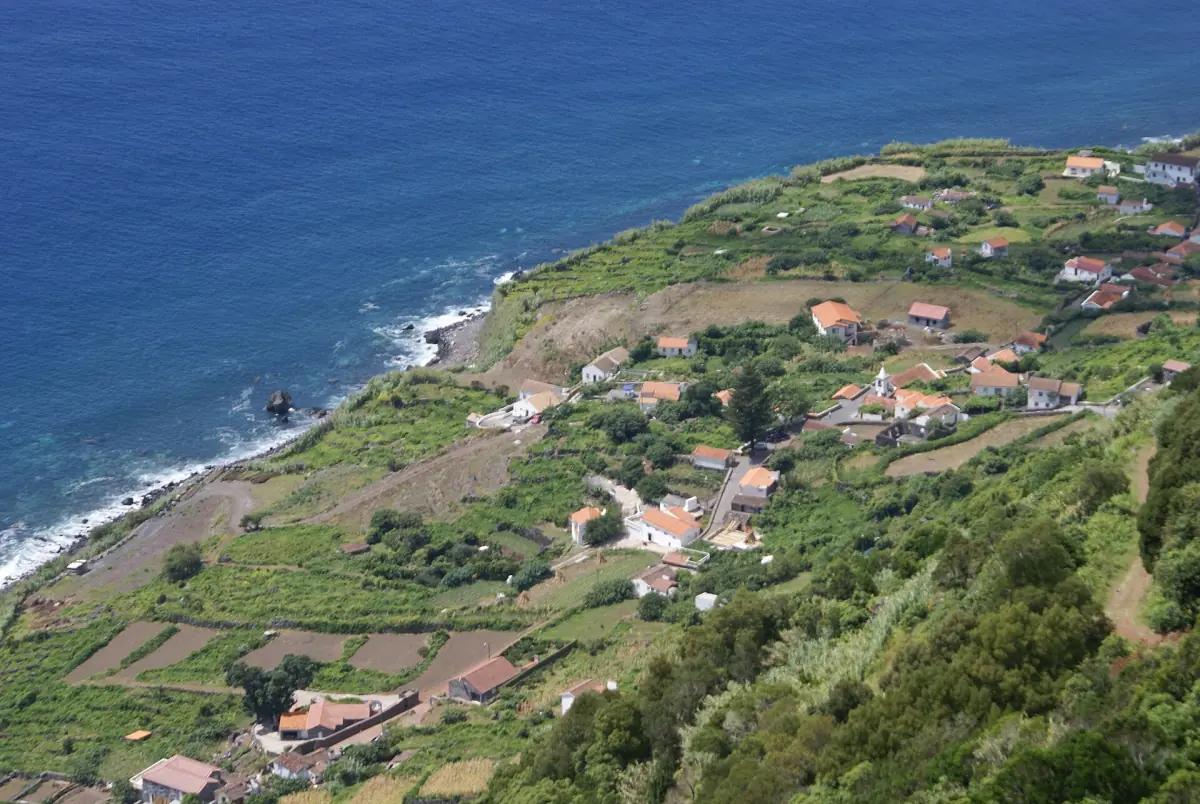 Coastal fajã below steep green cliffs on São Jorge island