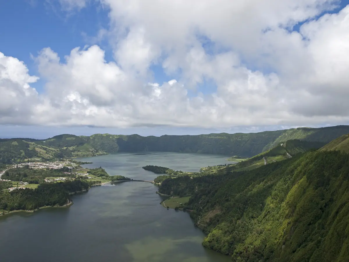 Sete Cidades crater lake and rim under towering clouds